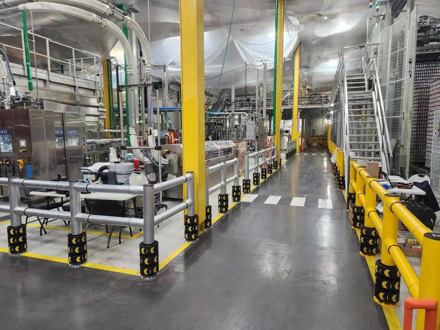 ENNAT barriers lining a Coca-Cola bottling line walkway