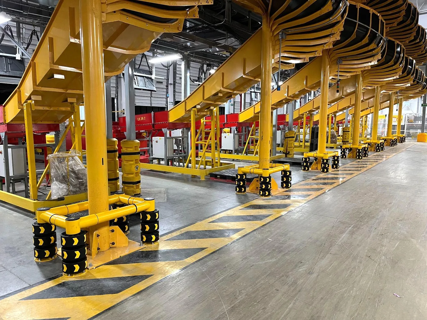 ENNAT guardrails protecting conveyor supports at a DHL Express facility