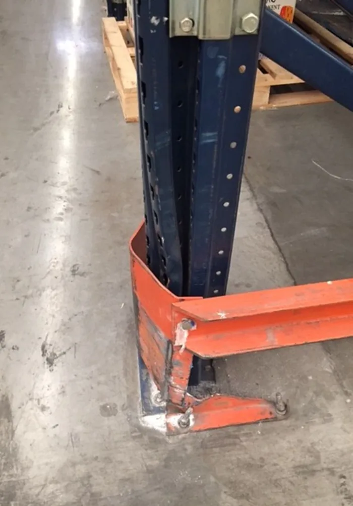 Rack protector deformed, with its anchor plate pulled out of the concrete slab